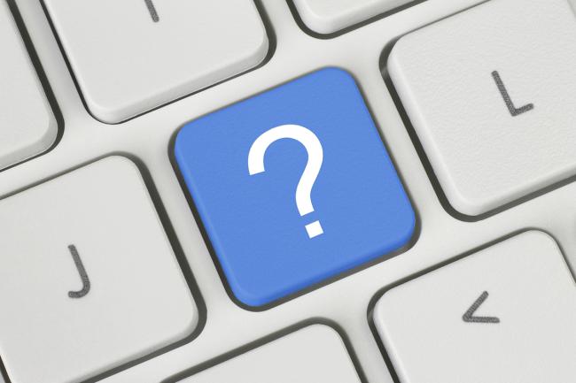 Blue question mark key on a keyboard