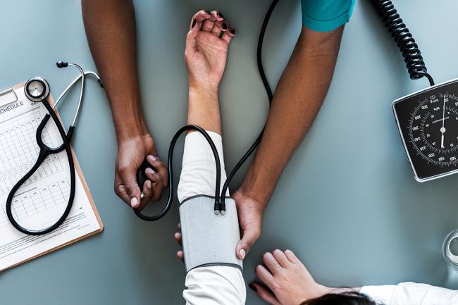 Image of a doctor giving a blood pressure test.